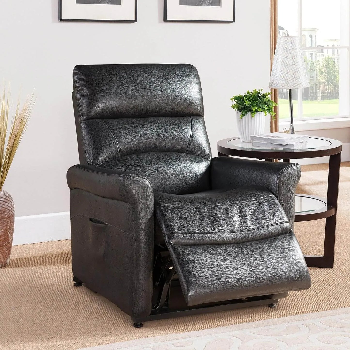 Black faux leather recliner chair in a living room setting with a side table and window in the background.