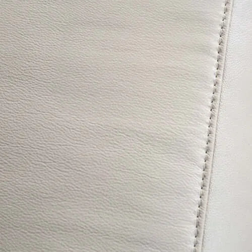 Close-up of beige leather with visible stitching