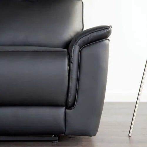 Close-up of a black leather armchair on a light background