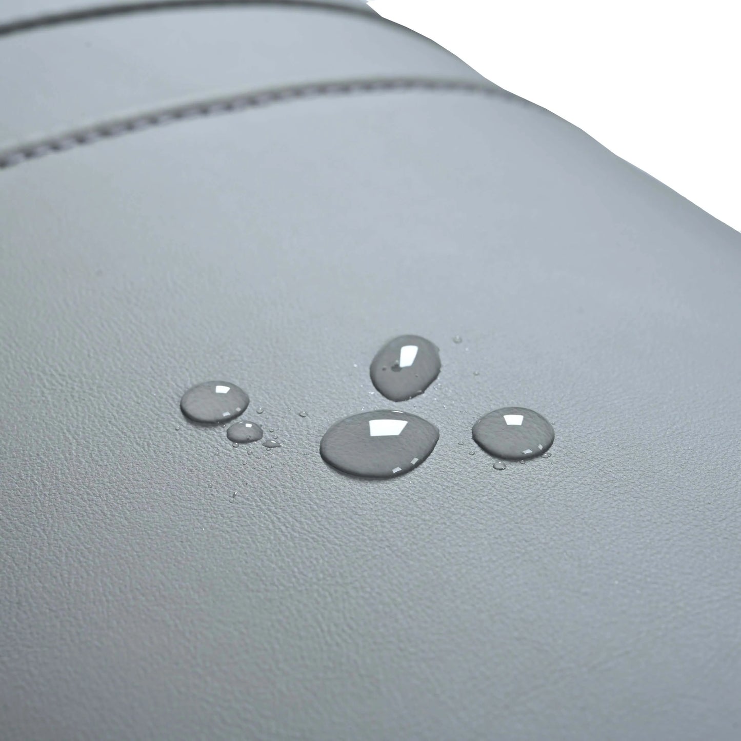Water droplets on a gray leather surface