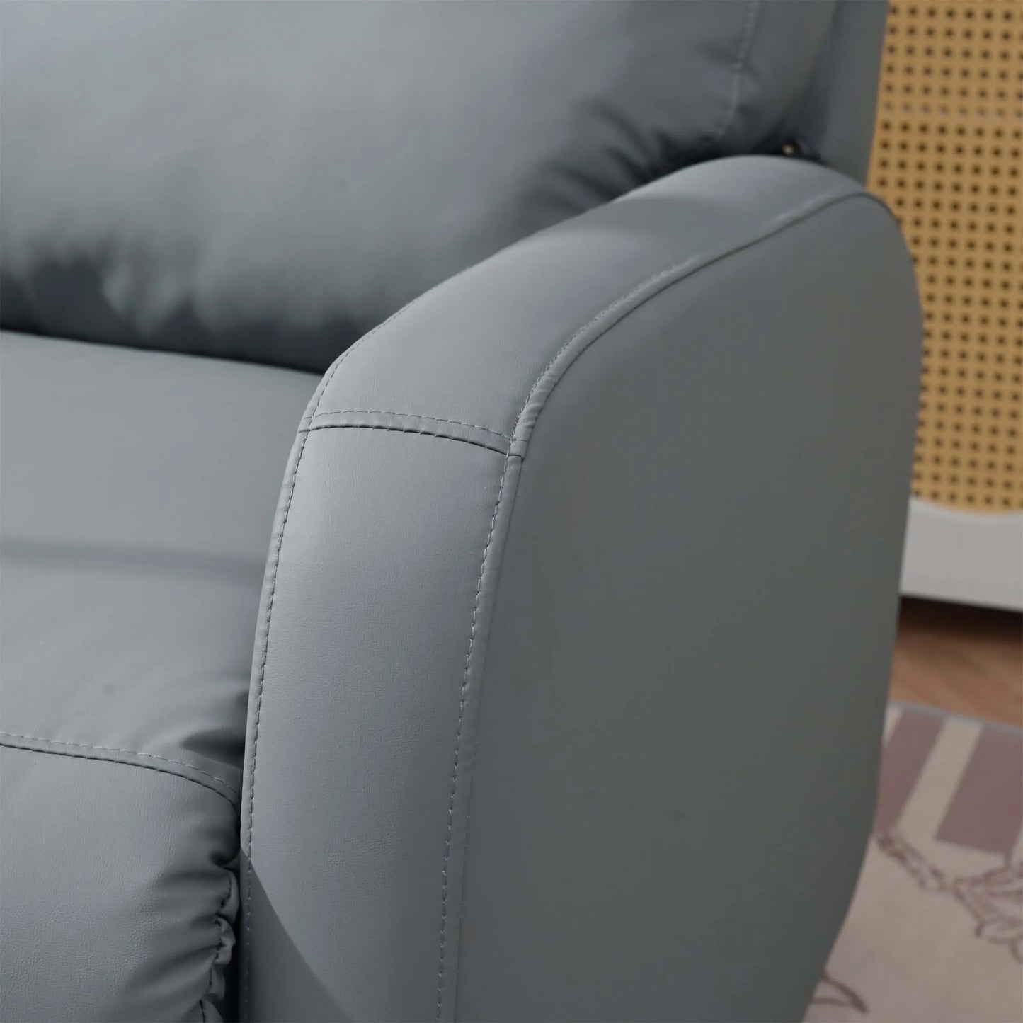 Close up of a gray recliner chair armrest with a blurred background