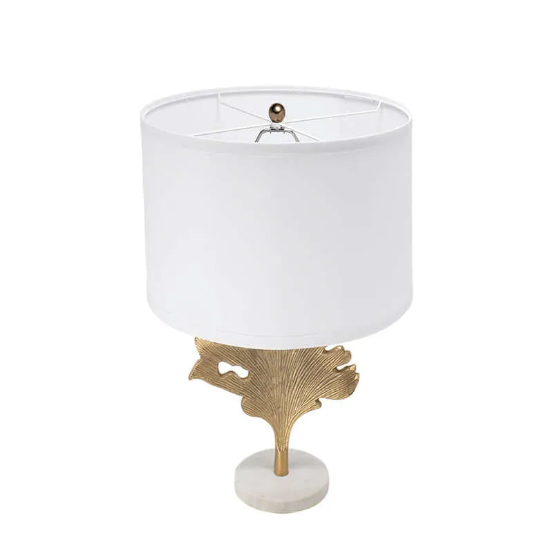 Table lamp with white shade , gold leaf and white marble base on a white background