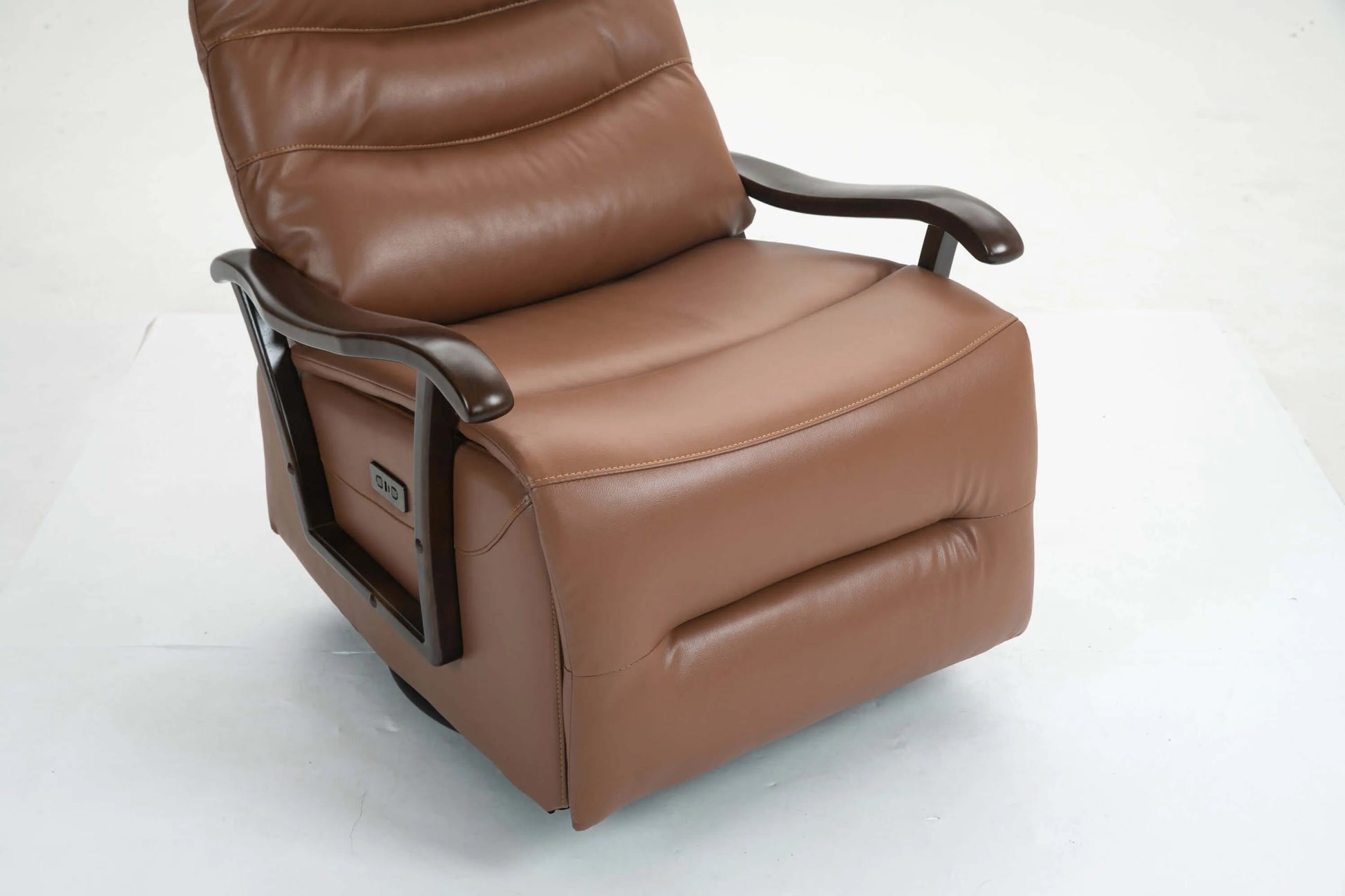 Close up of a brown leather recliner chair seat cushion on a white background