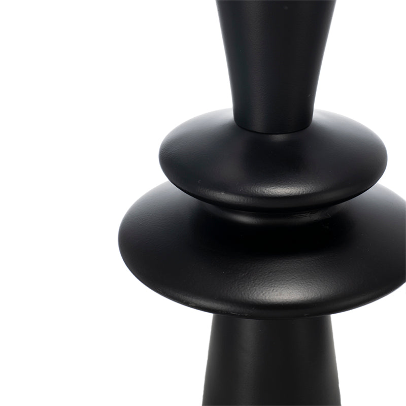Close-up of a black lamp base on a white background