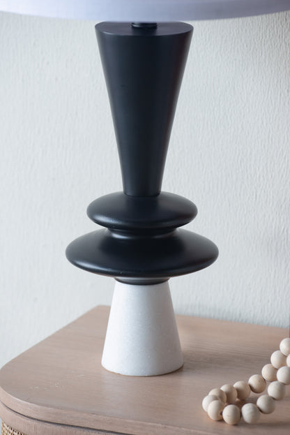 Black and white aluminum table lamp on a wooden surface with a white background