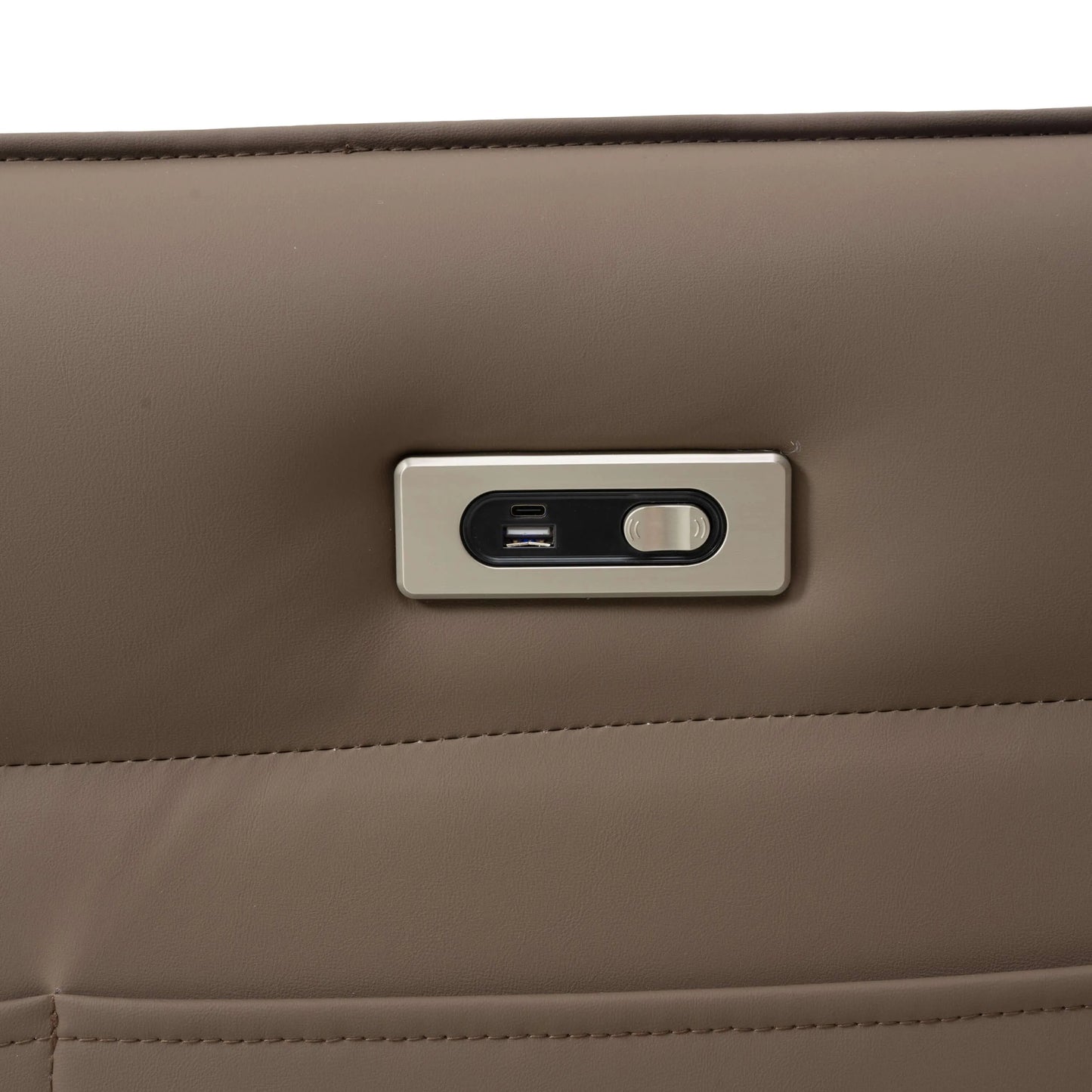Close-up power button and usb plug on a brown leather recliner chair.