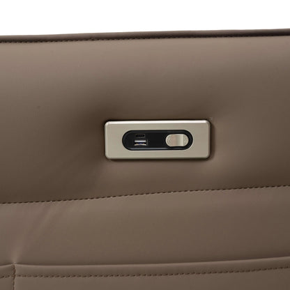Close-up power button and usb plug on a brown leather recliner chair.