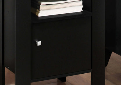 Close up of black and grey end table with a drawer and books on top shelf