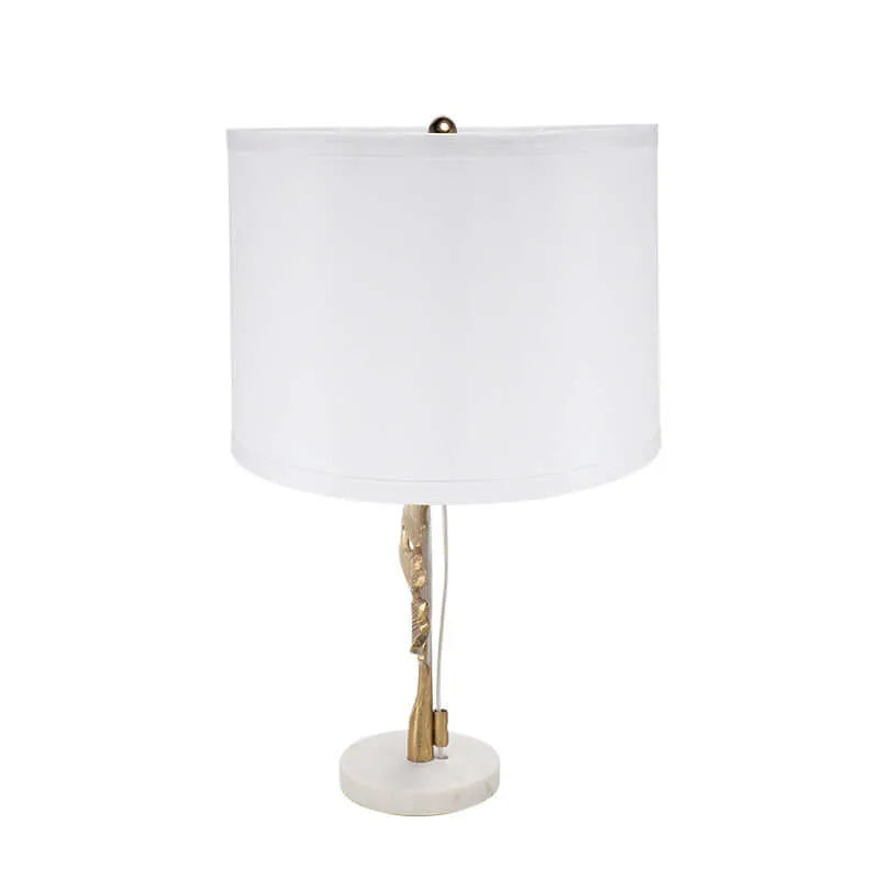 Table lamp with white shade and marble base on a white background