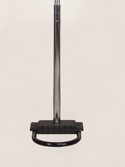 Black metal floor lamp base on a beige background