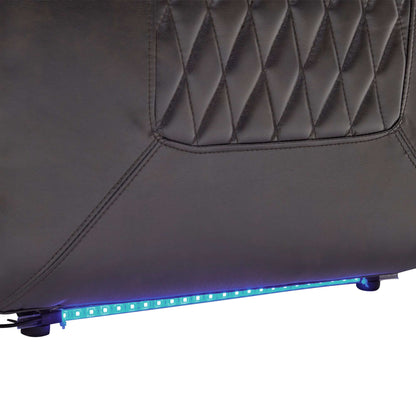 Close up of a blue LED strip at the bottom of a black faux leather power motion recliner chair on a white background