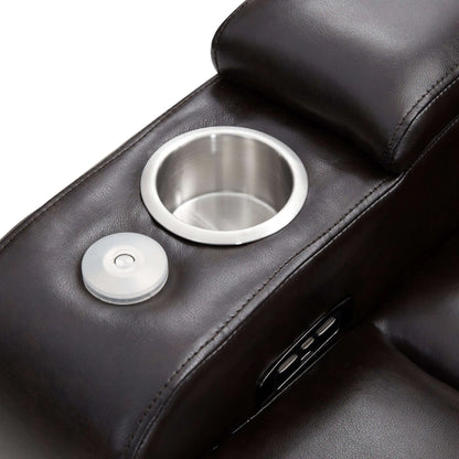 Close-up of a black faux leather power motion recliner chair arm rest with stainless steele cup holder and power button on a white background 