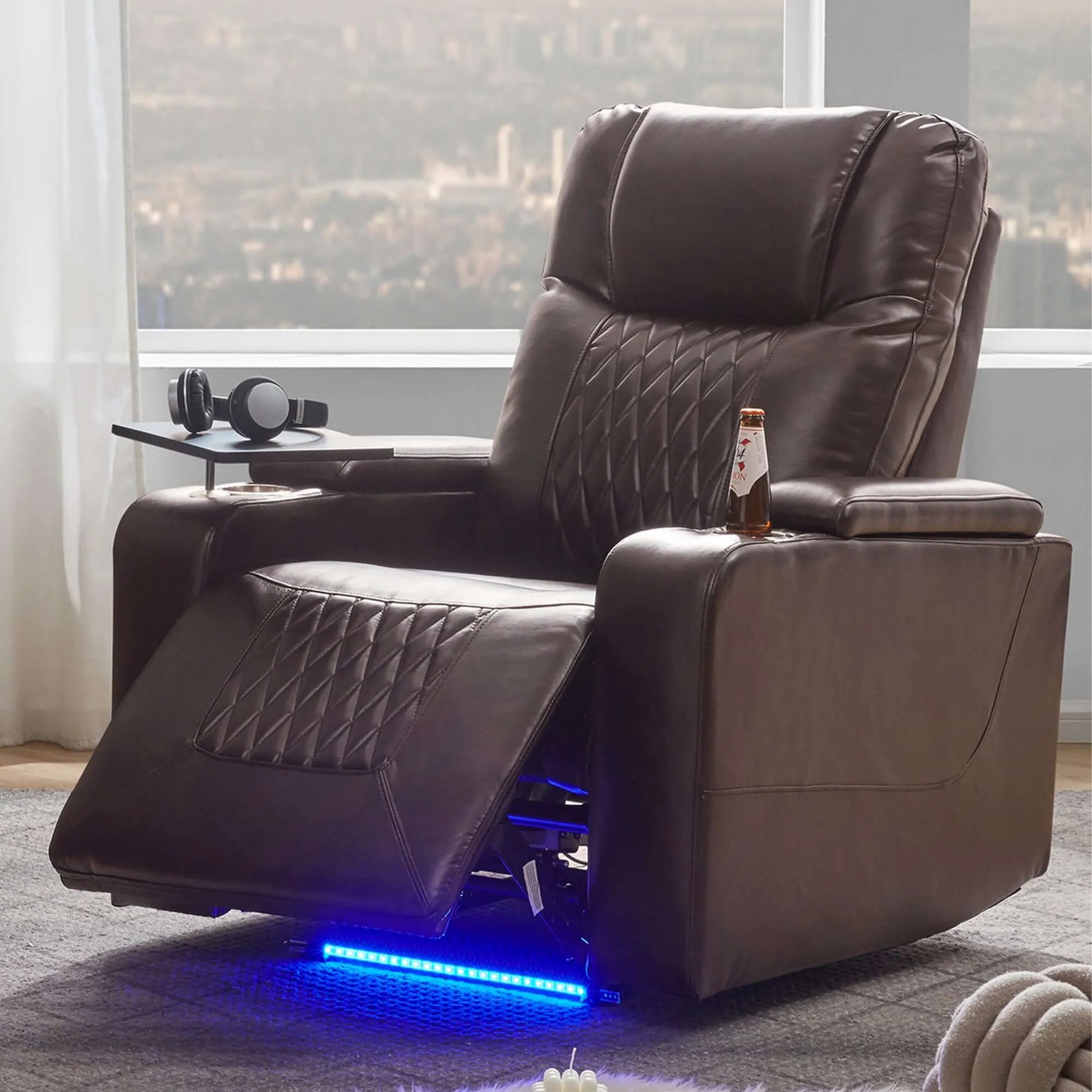 Brown faux leather power motion recliner chair with LED lighting in a room with large windows.