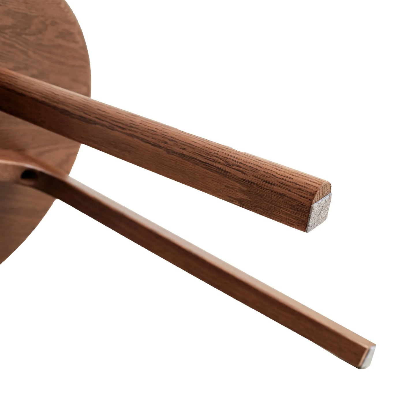 Close-up of a wooden end table legs on a white background