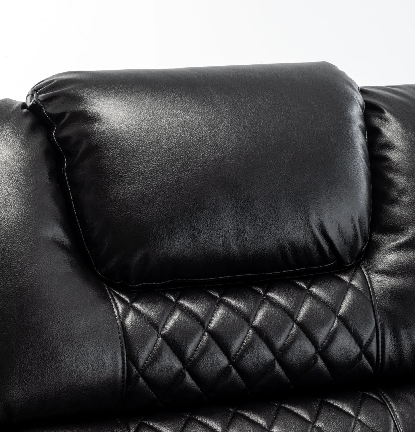 Close-up of a black leather recliner chair with quilted pattern