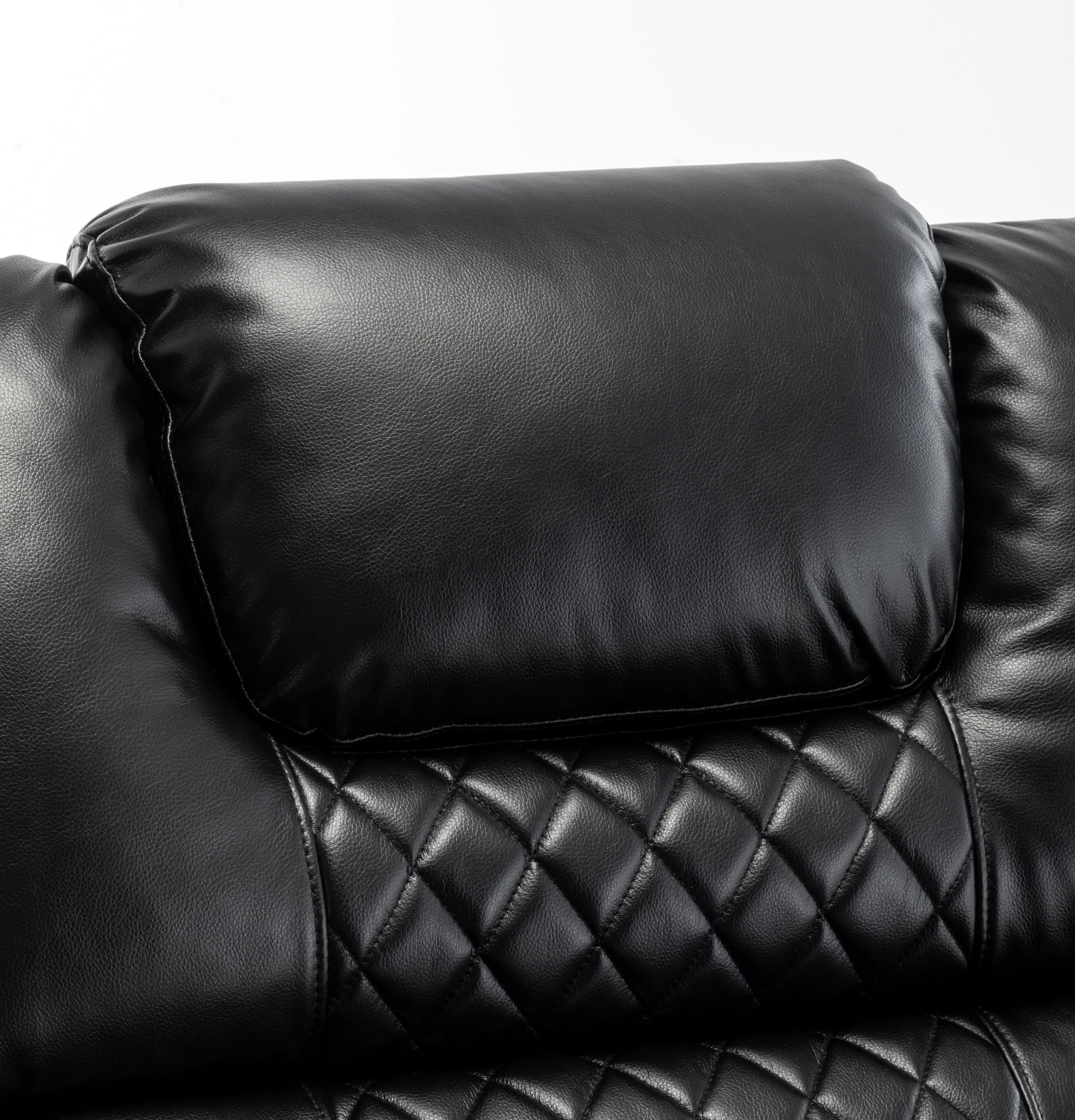 Close-up of a black leather recliner chair with quilted pattern