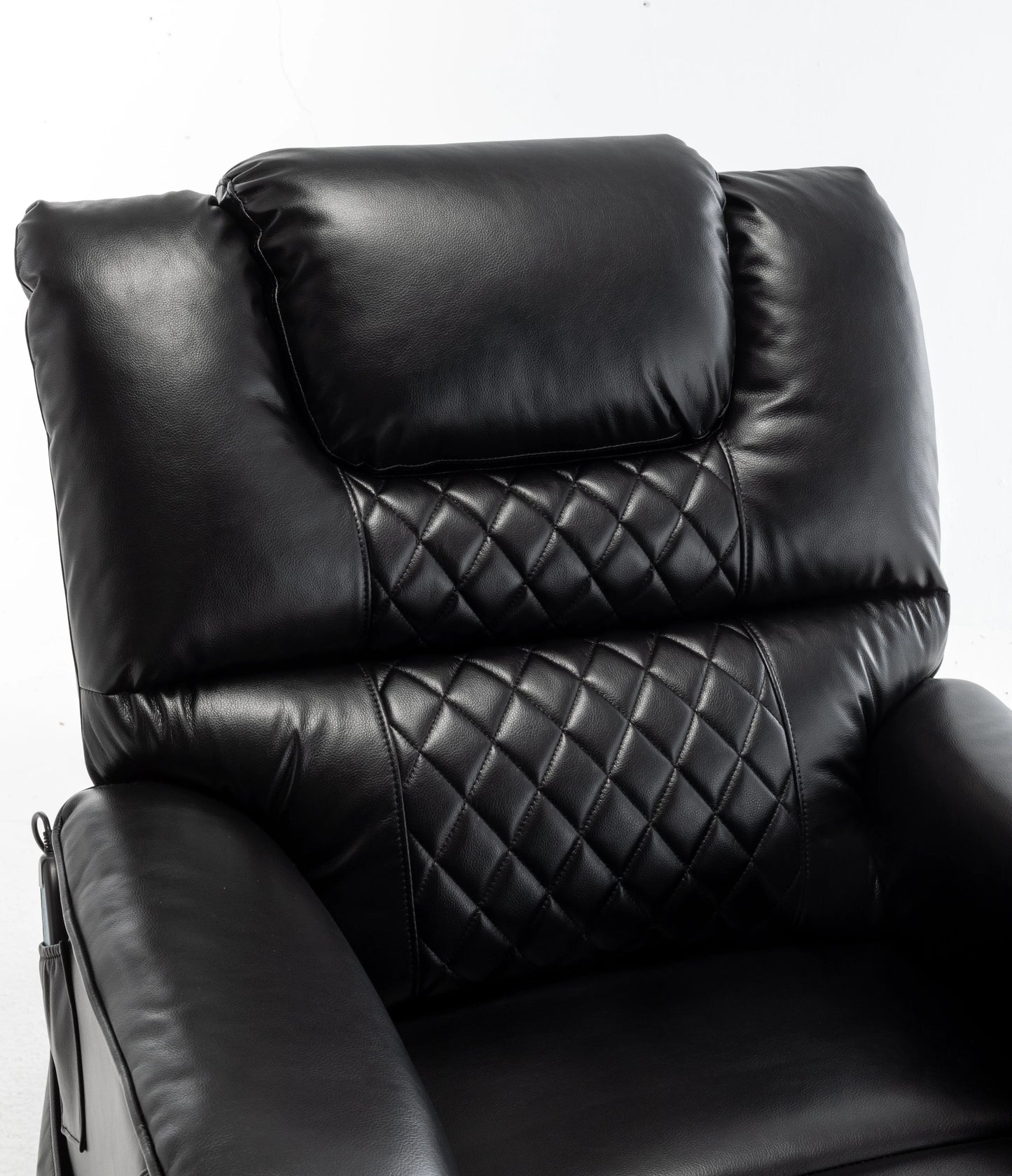 Black leather recliner chair with quilted pattern on a white background