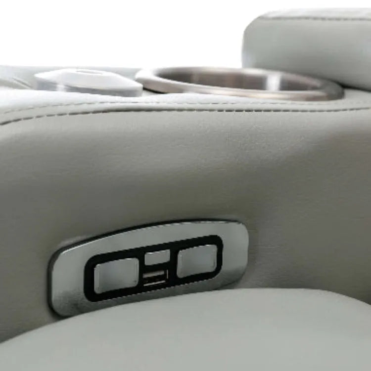 Close up of a gray faux leather USB plugs and reclining controls. 