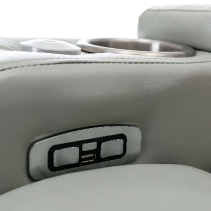 Close up of a gray faux leather USB plugs and reclining controls. 