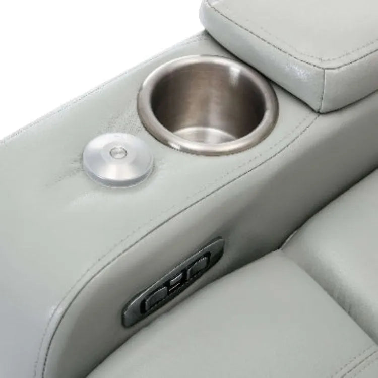 Close-up of a gray leather recliner chair cup holder, USB plugs and controls on a white background.