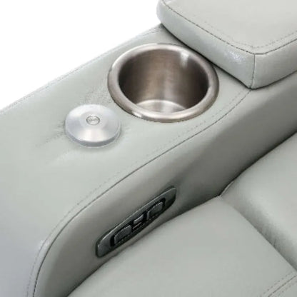 Close-up of a gray leather recliner chair cup holder, USB plugs and controls on a white background.