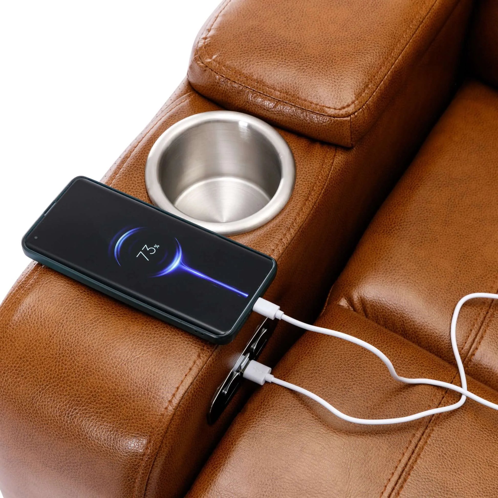 Smartphone with wireless charging pad attached to a brown leather recliner chair.