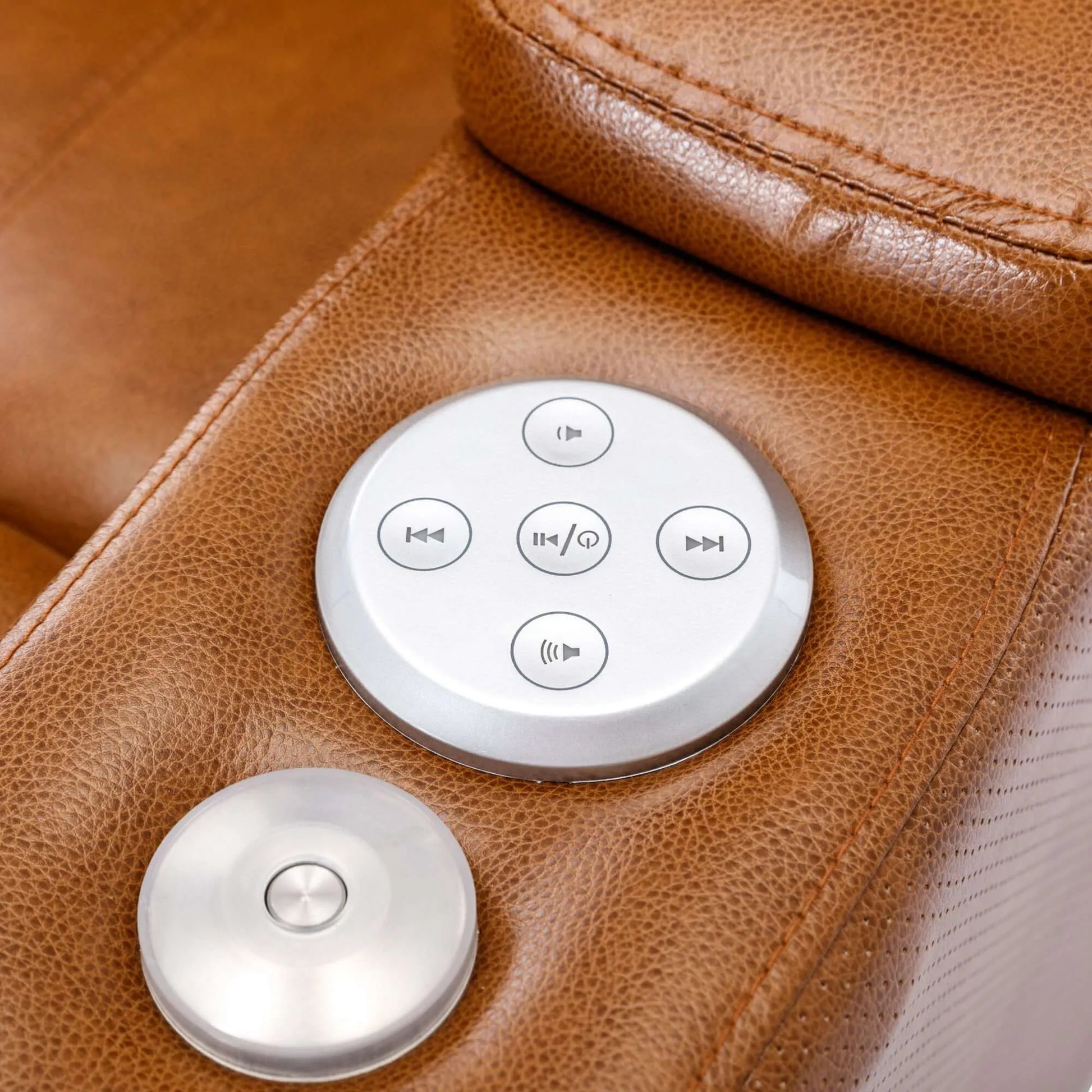 Control panel with buttons on a brown leather recliner chair