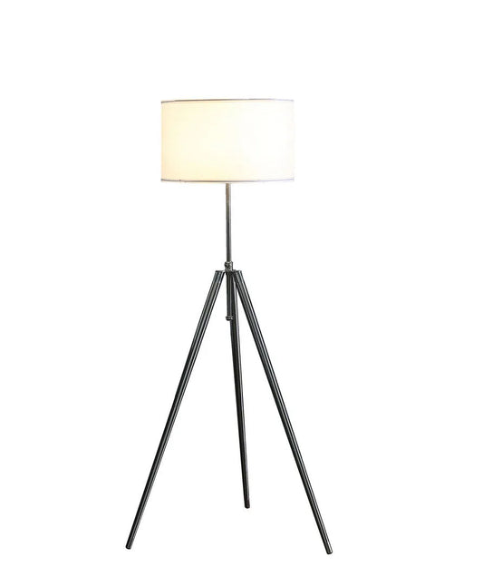 Tripod floor lamp with a white shade on a white background