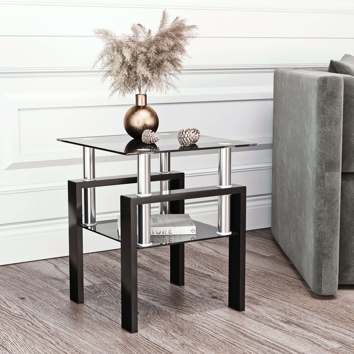 Modern end table with glass top and black metal legs in a living room setting.