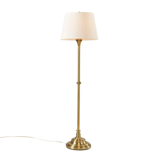 Floor lamp with a white drum shade on a white background