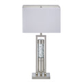 Table lamp with a white shade and decorative base on a white background