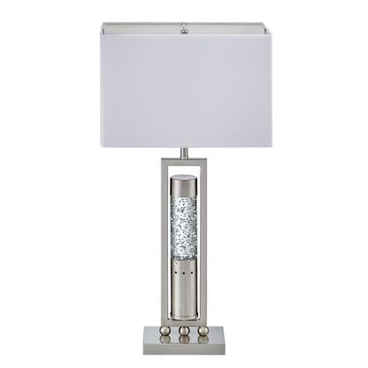 Table lamp with a white shade and decorative base on a white background