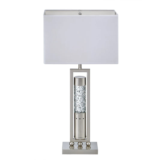 Table lamp with a white shade and decorative base on a white background
