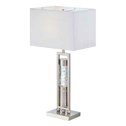 Table lamp with a white shade and decorative base on a white background