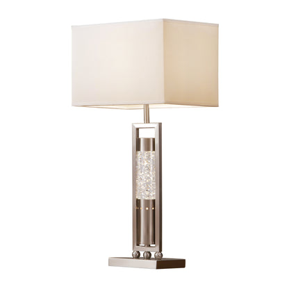 Table lamp with a beige shade and decorative base on a white background