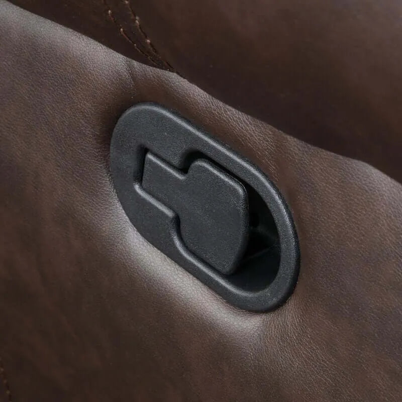 Close-up of manual latch on a brown faux leather glider recliner.