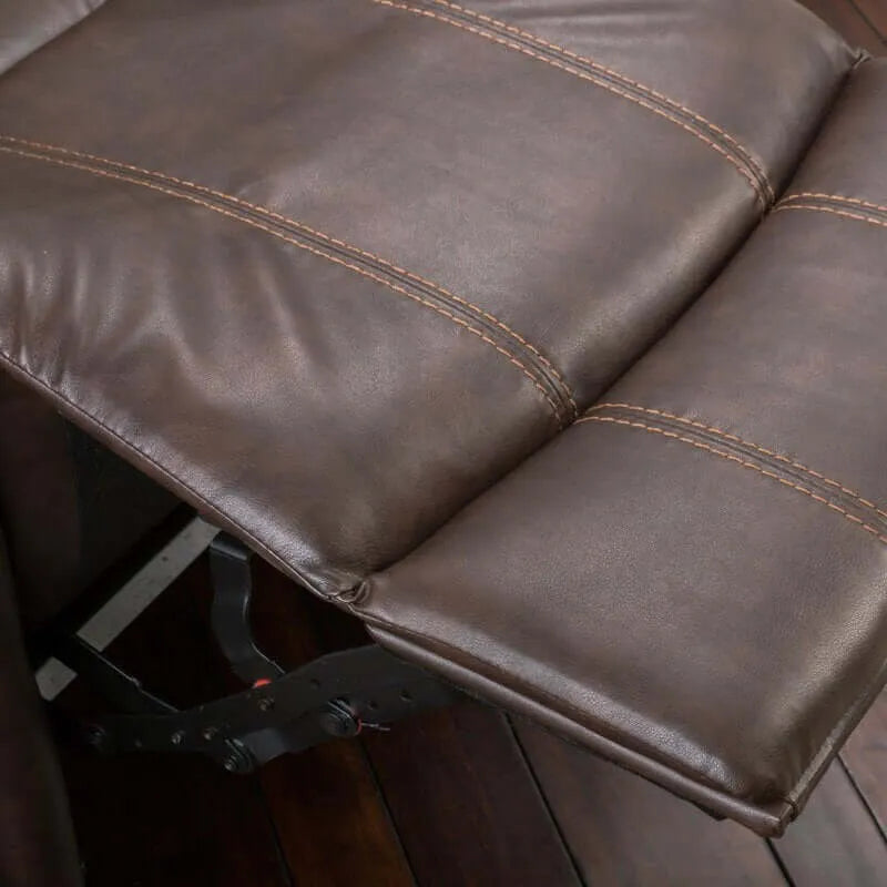 Close-up of brown faux leather glider recliner footrest with visible stitching on a wooden floor.