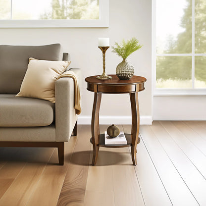 Round walnut wood end table with decorative items next to a gray sofa in a bright living room.