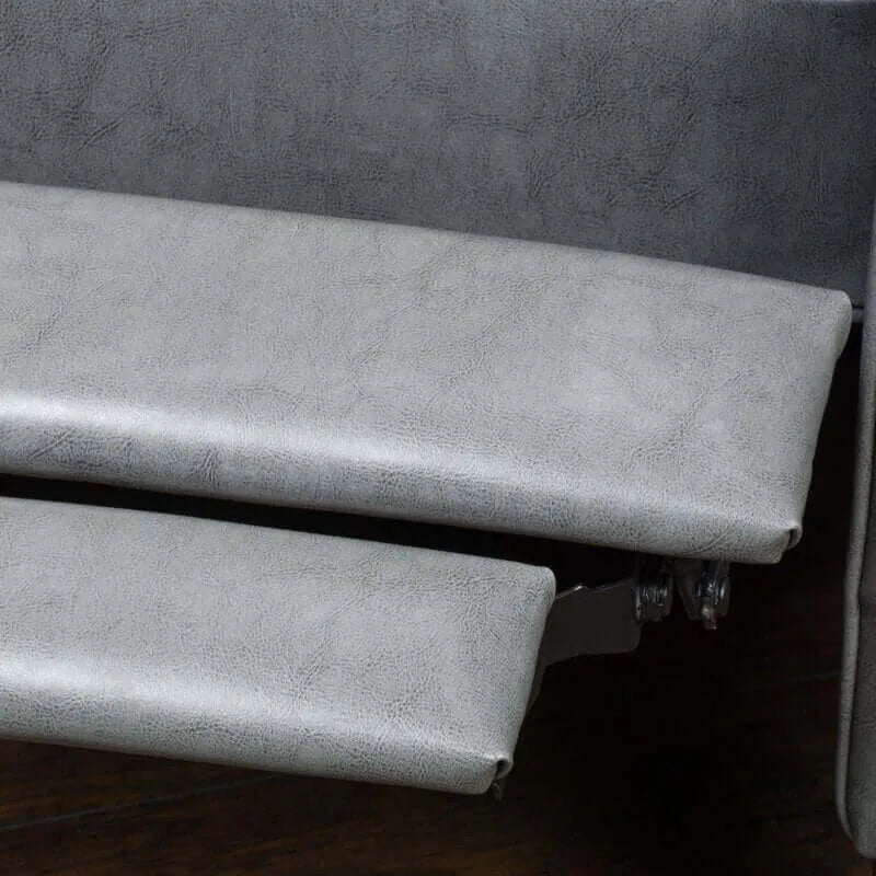 Gray fabric surface of a recliner chair with a wooden floor underneath