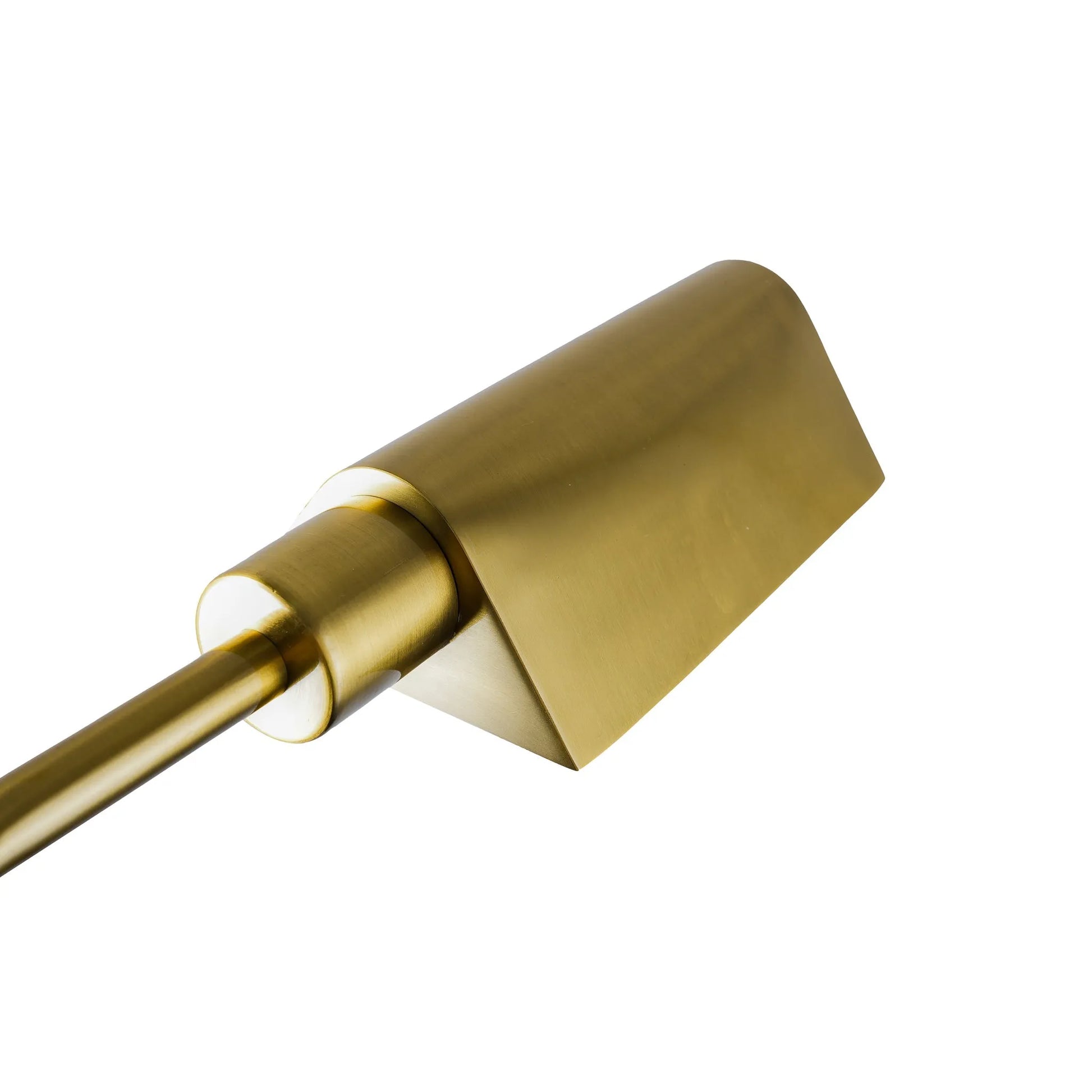 Close up of a brass lamp shade on a white background