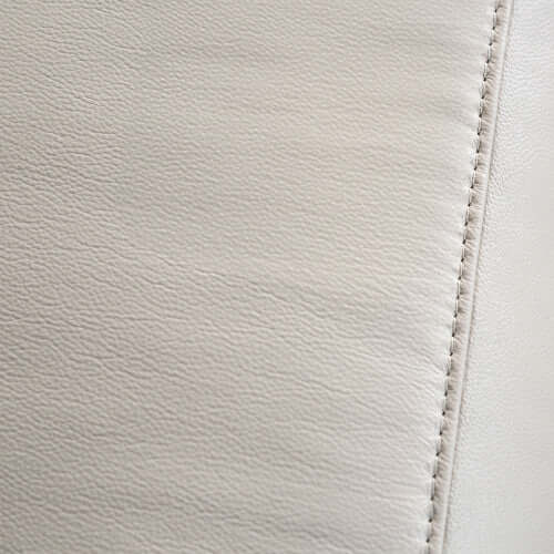 Close-up of beige leather with visible stitching