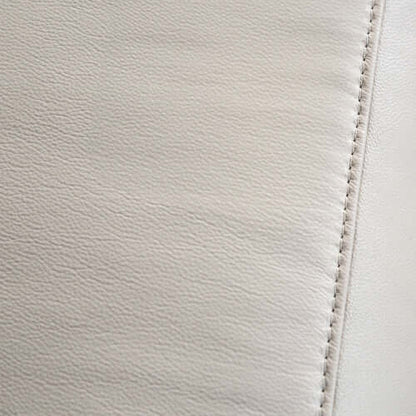 Close-up of beige leather with visible stitching