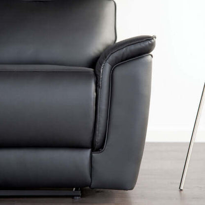 Close-up of a black leather armchair on a light background
