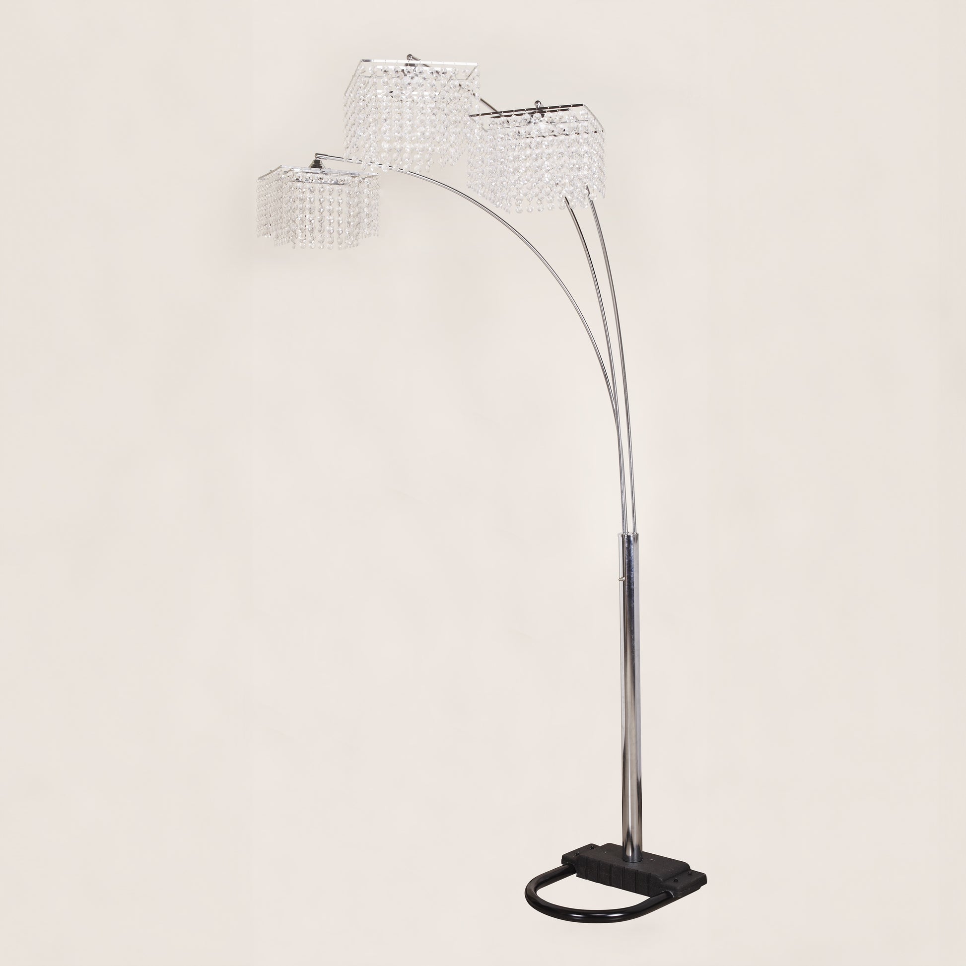 Arc floor lamp with crystal-like shades on a light gray background