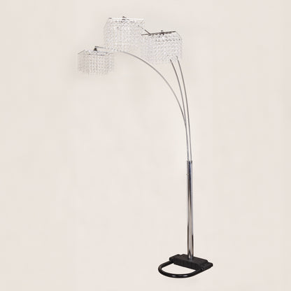 Arc floor lamp with crystal-like shades on a light gray background