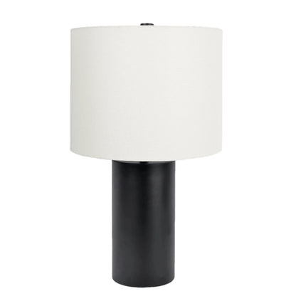 Table lamp with a black base and white drum shade on a white background