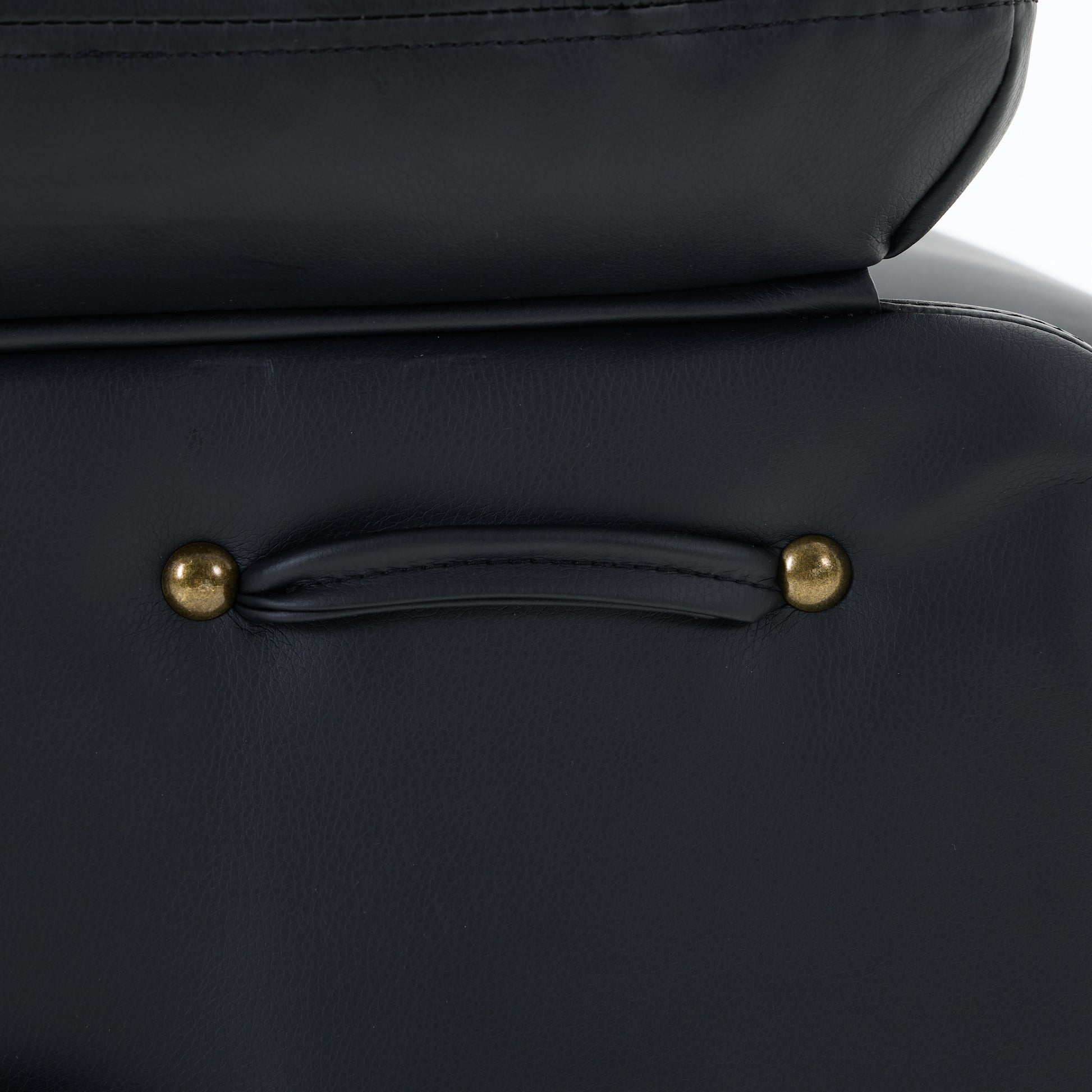 Close-up of a black leather recliner chair decorative detail on a white background