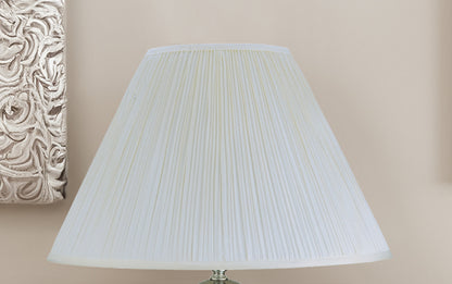 White pleated lampshade on a beige background