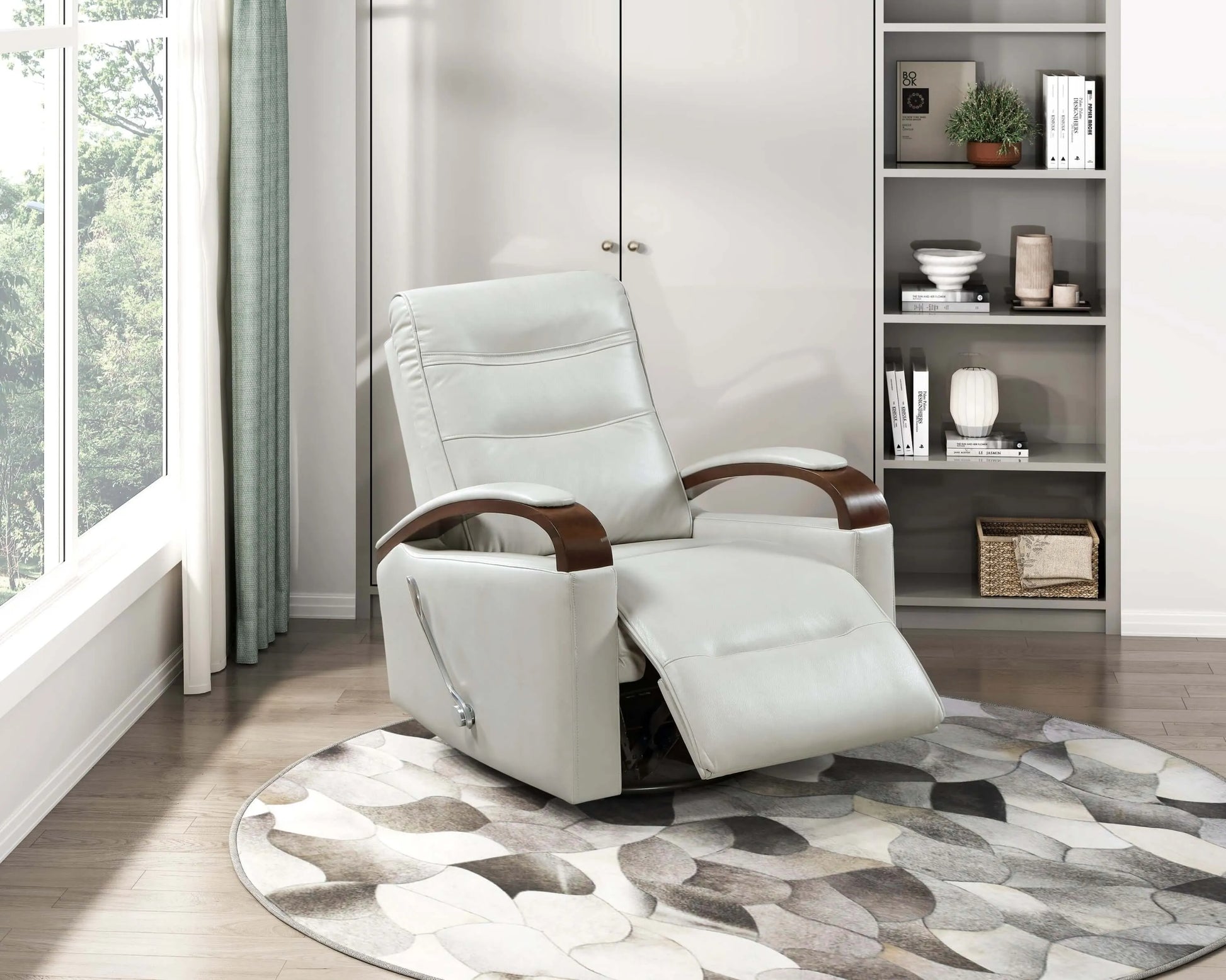 Gray recliner chair with wooden armrests in a room with a bookshelf and window.
