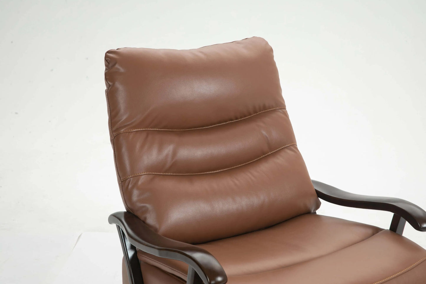 Brown leather recliner chair cushion close up with stitching details on a white background
